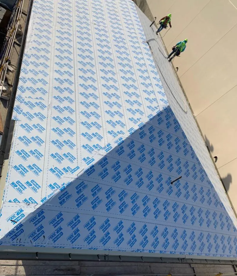 Professional roofers installing underlayment on a metal roof in Rocklin